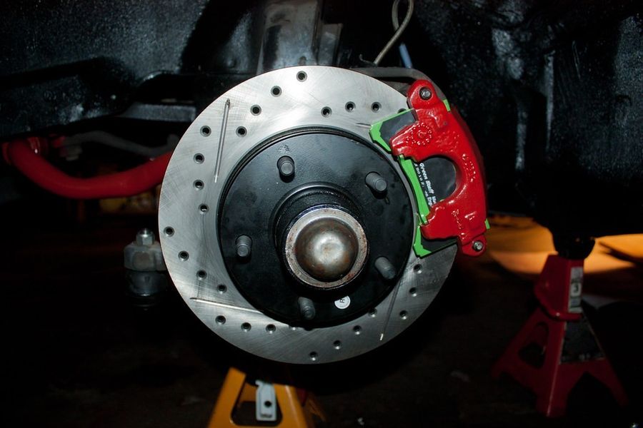 Drilled brake rotor with red caliper