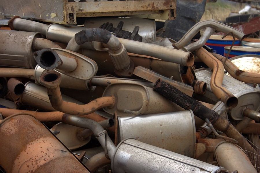 Pile of old mufflers and exhaust pipes